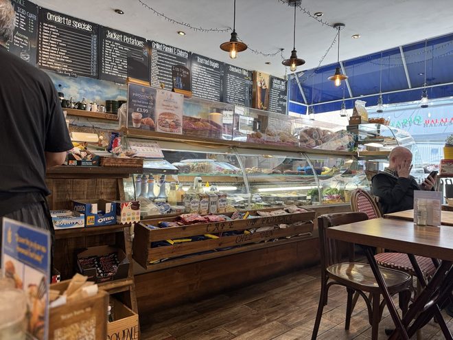 View down the length of the deli counter with seating to the right