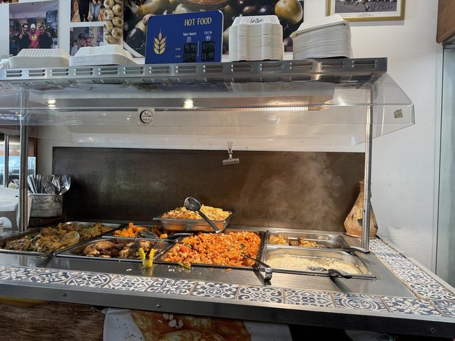 Trays of hot cooked dishes on the servery counter